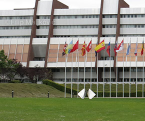 Council of Europe building with row of international flags