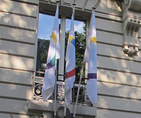 Flag of La Francophonie hanging from a building