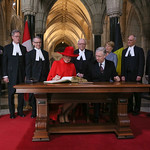 Their Majesties the King and the Queen of the Belgians signing the Distinguished Visitors' Book of the Senate and of the House of Commons at the Parliament of Canada during their State visit